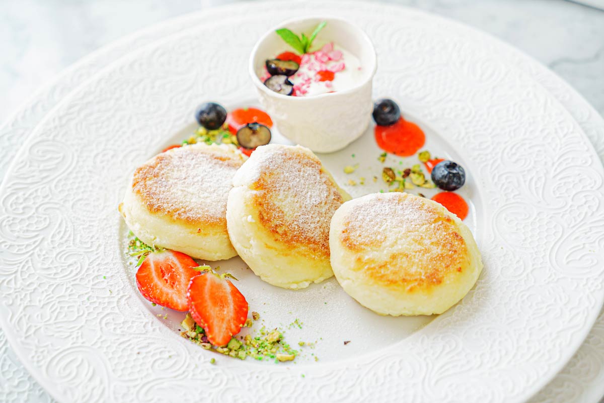 A plate of souffle pancakes with berries